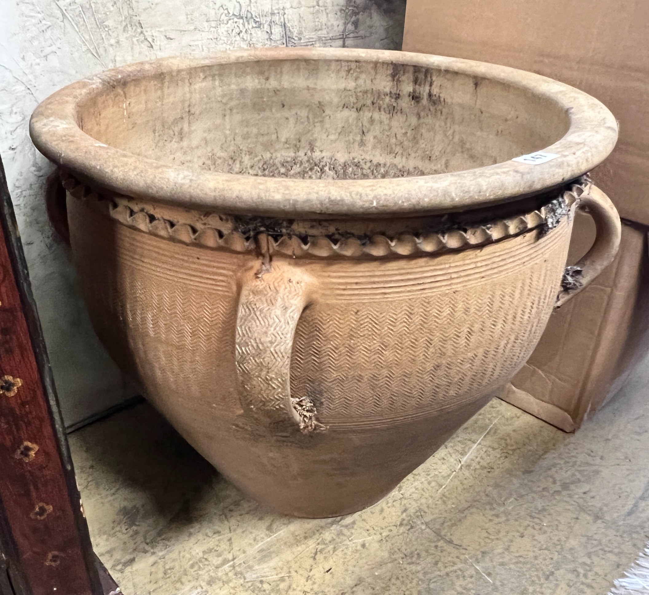 A circular terracotta planter, diameter 56cm, height 47cm